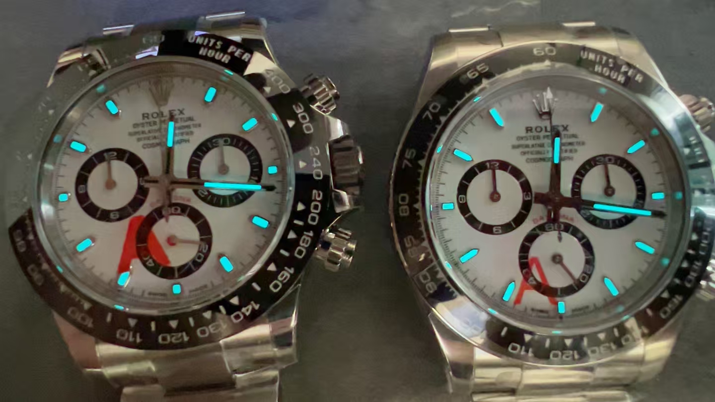 Two VSF Daytona white dial samples under blue lume illumination